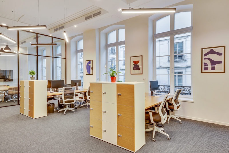 Flexible office space with several desks, chairs, and storage units